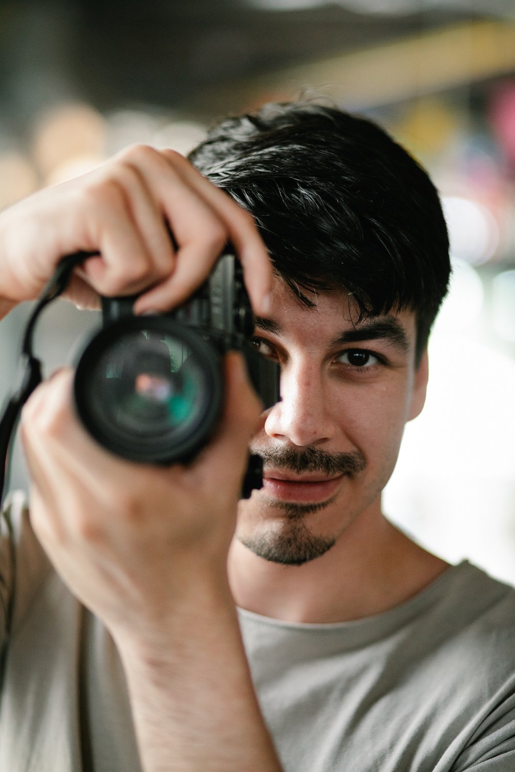 Man in Crew Neck Shirt Holding Black Dslr Camera